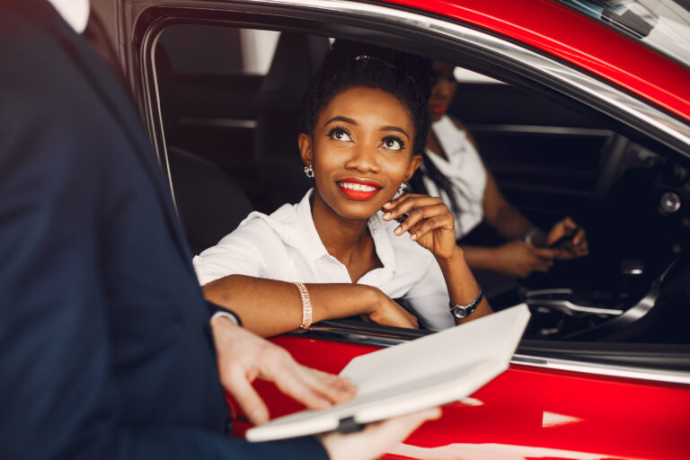 Two stylish black women in a car salon